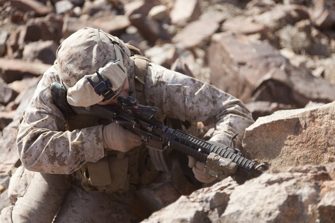 U.S. Marine Corps Cpl. Richard Rosales, a rifleman with 2nd platoon, Company A, 1st Battalion, 4th Marines, 5th Marine Regiment, fires his M-16A4 Assault Rifle during range 410 on Marine Corps Air Ground Combat Center Twentynine Palms, Calif., Dec. 1, 2012. Range 410 is a platoon fire and maneuver exercise held as part of Exercise Steel Knight. Exercise Steel Knight is an annual training exercise held to demonstrate the 1st Marine Division's abilities in a simulated combat scenario. (U.S. Marine Corps photo by Cpl. Jonathan R. Waldman/Released)