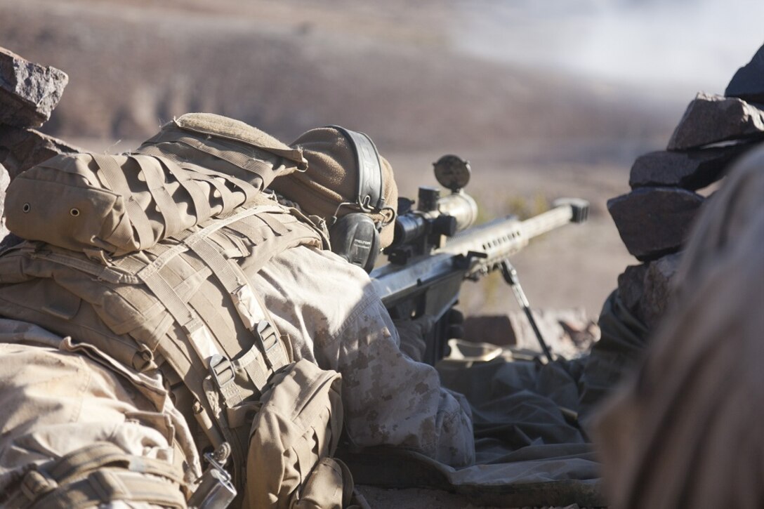 U.S. Marine Corps Lance Cpl. Kyle Janssen, assistant team leader with scout sniper team 1, scout sniper platoon, 1st Battalion, 4th Marines , 5th Marine Regiment, fires his XM107 Sniper Rifle during range 401 on Marine Corps Air Ground Combat Center  Twentynine Palms, Calif., Dec. 4, 2012. Range 401 is a company maneuver and fire exercise held as part of Exercise Steel Knight. Exercise Steel Knight is an annual training exercise held to demonstrate the 1st Marine Division's abilities in a simulated combat scenario. (U.S. Marine Corps photo by Cpl. Jonathan R. Waldman/Released)