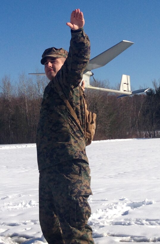 Cpl. Lincoln Weiss, a chemical, biological, radiological and nuclear defense specialist with Headquarters Company, 25th Marine Regiment, prepares to launch the RQ-11B unmanned aerial vehicle during a training flight here, March 9. The UAV operators participated in training flights at the Devens Reserve Forces Training Area to sustain flight procedures and techniques in preparation for training exercises African Lion in April and Heavy Metal in June. 