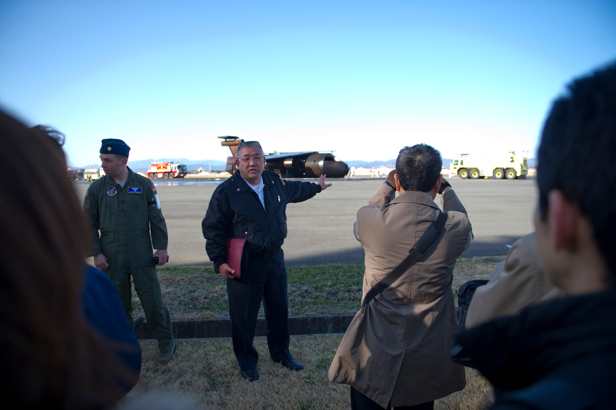 YOKOTA AIR BASE, Japan -- Nobuhiko Nishimura, 374th Civil Engineer Squadron fire inspector, explains the exercise scenario to North Kanto Defense Bureau liaisons during an emergency management exercise at Yokota Air Base, Japan, Mar. 21, 2013. The EME was held in an effort to strengthen Yokota’s bilateral capability with local Japanese response teams. (U.S. Air Force photo by SSgt Chad C. Strohmeyer)