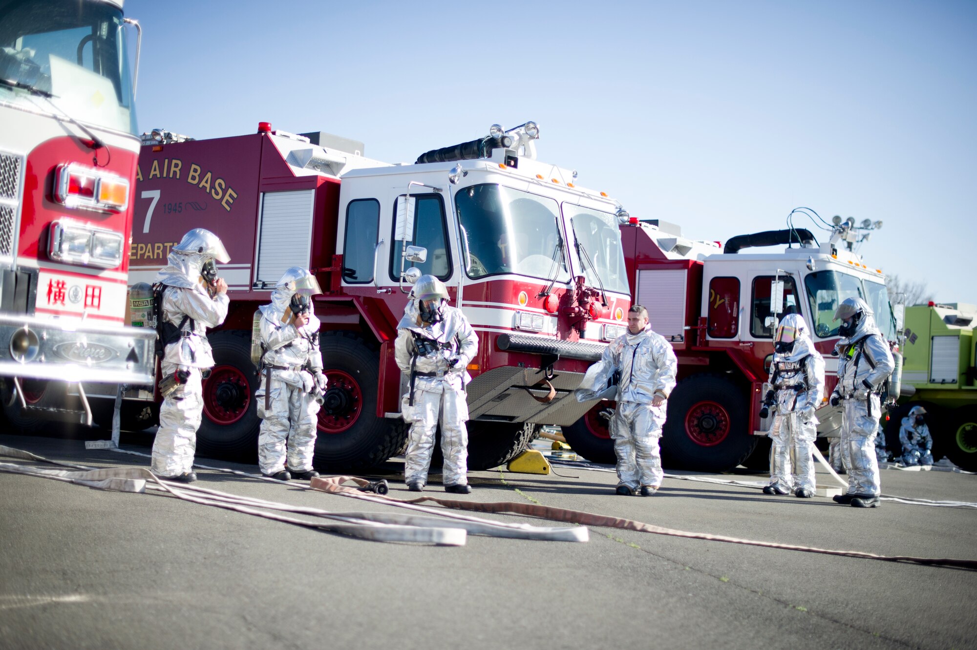 YOKOTA AIR BASE, Japan -- Firefighters from the 374th Civil Engineer Squadron prepare to respond during a joint emergency management exercise at Yokota Air Base, Japan, March 21, 2013. The EME gives first responders the opportunity to practice and fine-tune their life saving skills and procedures. (U.S. Air Force photo by Staff Sgt. Stacy Moless)
