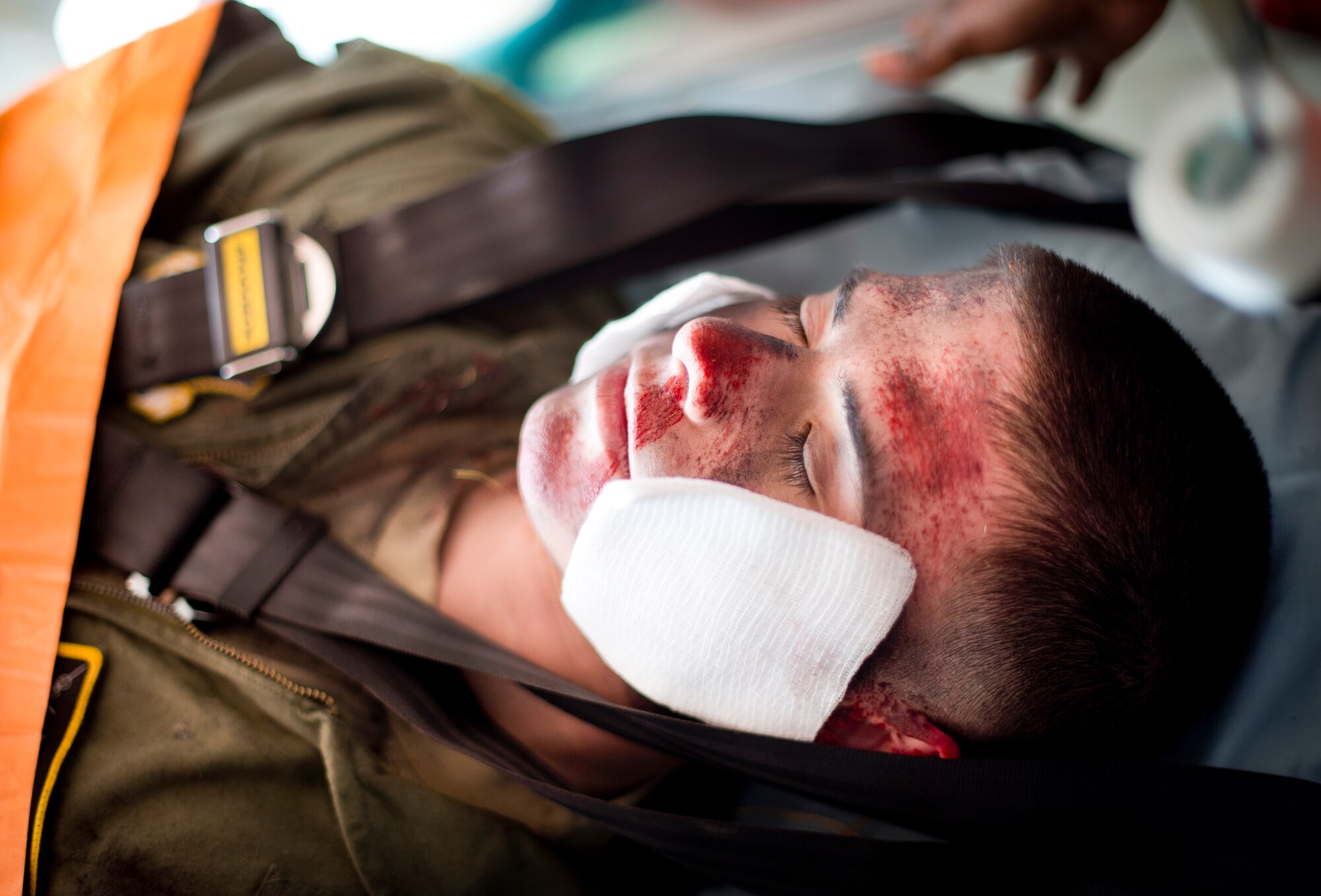 YOKOTA AIR BASE, Japan -- Airman 1st Class Paul Hensley, 36th Airlift Squadron loadmaster is placed into an ambulance March 21, 2013 during a joint emergency management exercise at Yokota Air Base, Japan. The exercise focused on mass-casualty training scenarios giving first responders hands on practice for crisis situations. (U.S. Air Force photo by Staff Sgt. Stacy Moless)