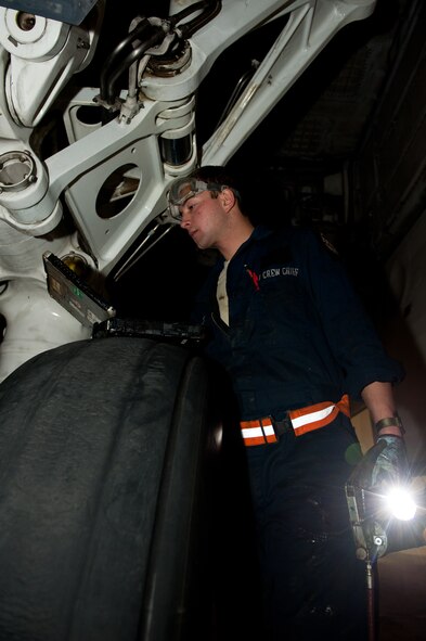 Airman 1st Class Justin Hollis, 28th Aircraft Maintenance Squadron B-1 crew chief, consults his technical order before lubricating parts of a B-1 after it was washed during an Operational Readiness Exercise at Ellsworth Air Force Base, S.D., March 20, 2013. OREs ensure Ellsworth Airmen maintain their combat-ready edge, and are ready to deploy rapidly in the event of real-world contingencies. (U.S. Air Force photo by Airman 1st Class Kate Thornton-Maurer/Released) 