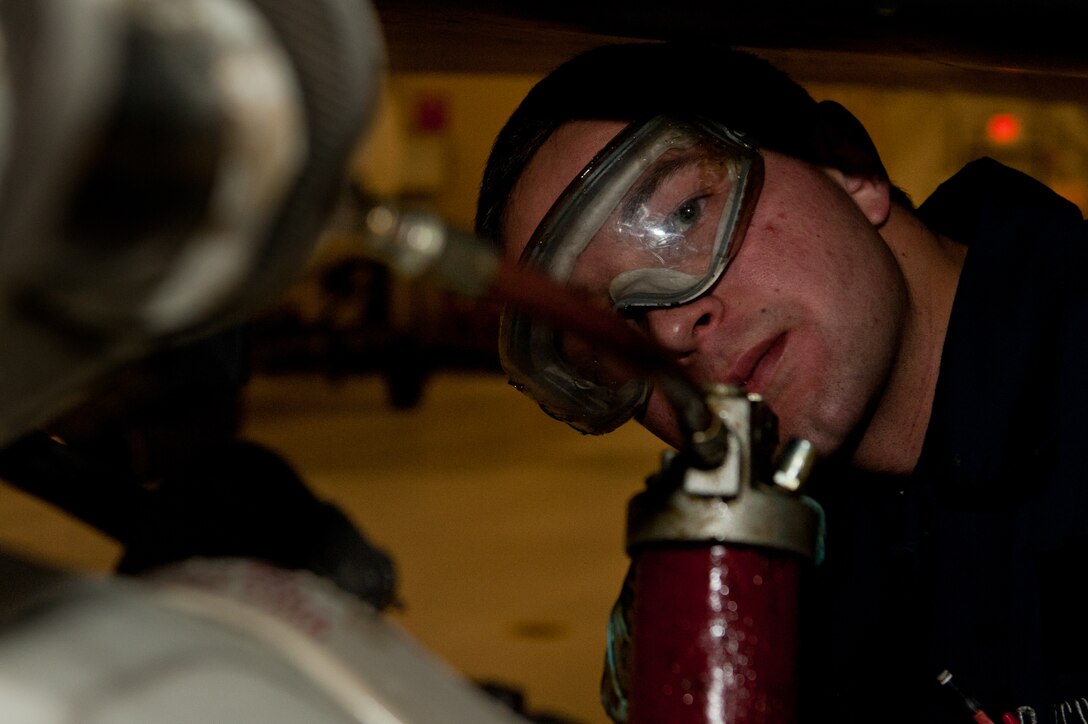 Airman 1st Class Justin Hollis, 28th Aircraft Maintenance Squadron B-1 crew chief, lubricates landing gear after an aircraft wash during an Operational Readiness Exercise at Ellsworth Air Force Base, S.D., March 20, 2013. The wash removes lubrication that must be reapplied to reduce friction and keep Airmen and aircrafts safe. (U.S. Air Force photo by Airman 1st Class Kate Thornton-Maurer/Released) 