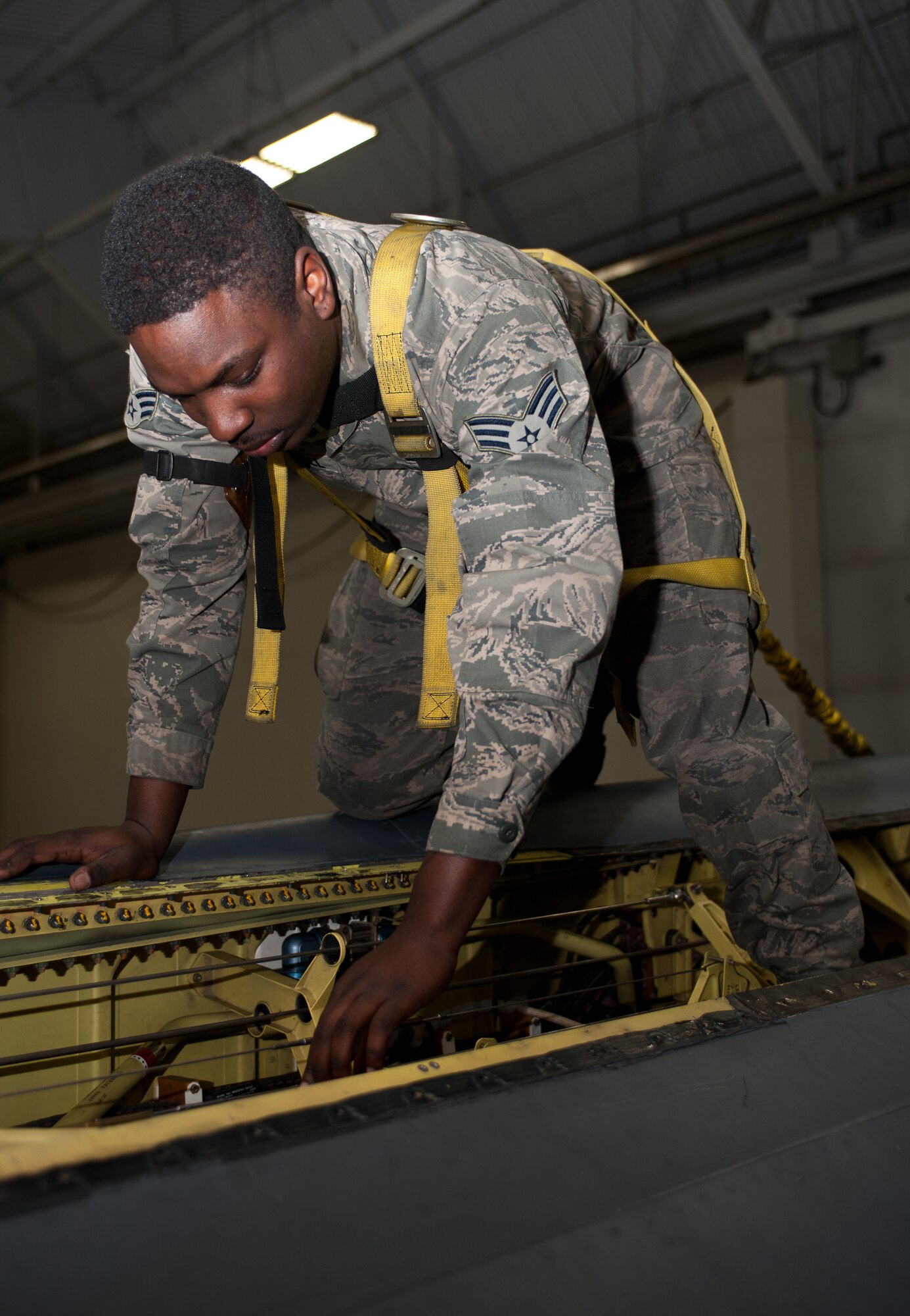Senior Airman Mandez Cardwell, 28th Aircraft Maintenance Squadron electro-environmental technician, installs a bleed duct into a B-1 during an Operational Readiness Exercise at Ellsworth Air Force Base, S.D., March 20, 2013. Cardwell was accomplishing work required for a required 1,800 day maintenance inspection. (U.S. Air Force photo by Airman 1st Class Alystria Maurer/Released)
