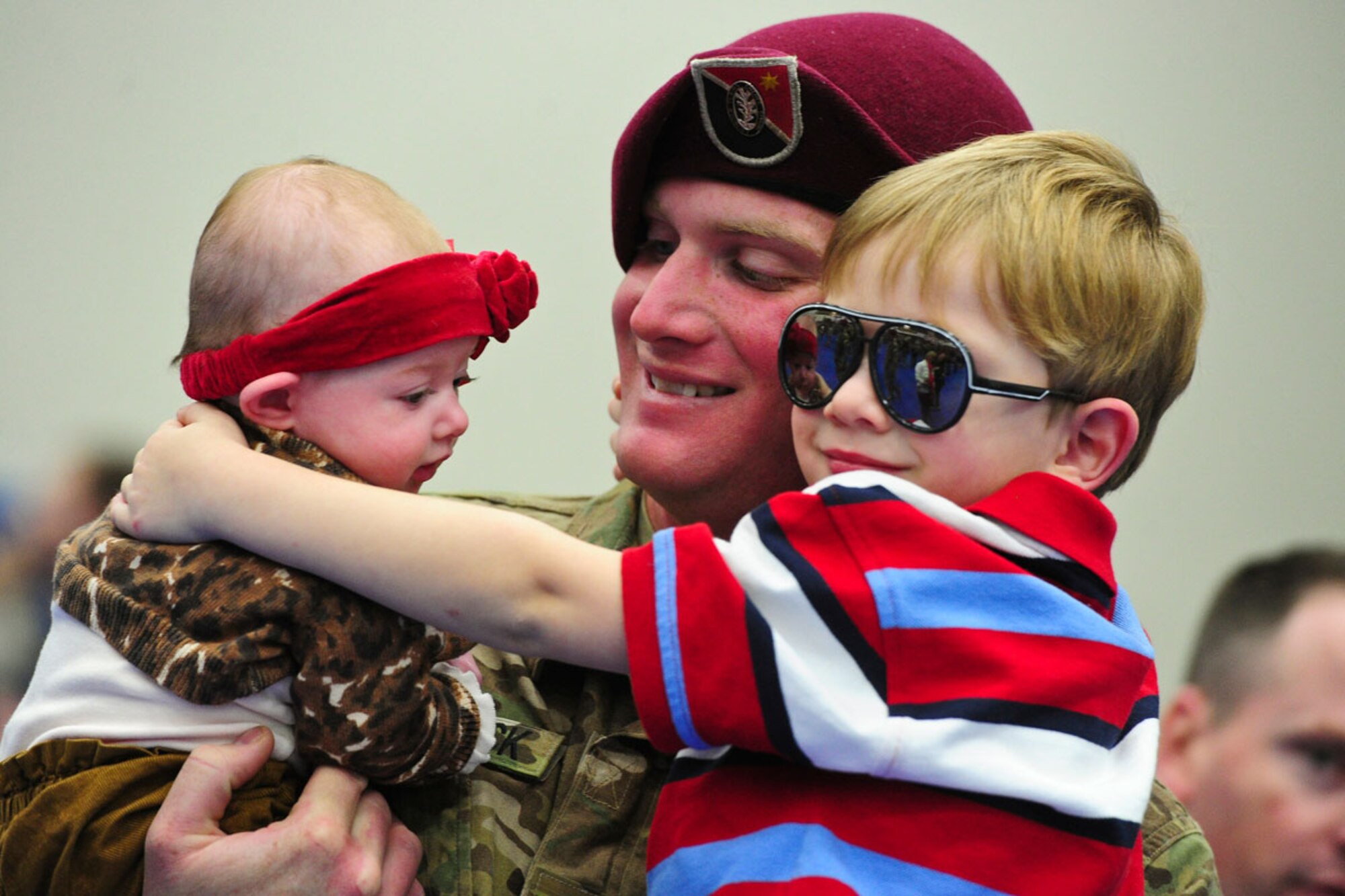 Staff Sgt. Brian Comstock, a native of Elmira, N.Y., holds his son, Bryson, 4, and daughter Stella, 3 months, after a redeployment ceremony at Buckner Physical Fitness Center on JBER March 14. Nearly 100 U.S. Army Alaska Soldiers returned home to JBER March 14 from a nine-month deployment to the southern provinces of Afghanistan in support of Operation Enduring Freedom. The Soldiers are assigned to the 23rd Engineer Company, part of the 6th Engineer Battalion, 2nd Engineer Brigade, home-based at JBER. During the Sappers’ deployment, the Soldiers performed dangerous route-clearance missions to remove improvised explosive devices along often-used roads to reduce the dangers of travel. The unit was featured in the National Geographic Channel’s “Bomb Hunters: Afghanistan,” and three-part Discovery Channel documentary “Heroes of Hell’s Highway.” (U.S. Air Force photos/Justin Connaher) 