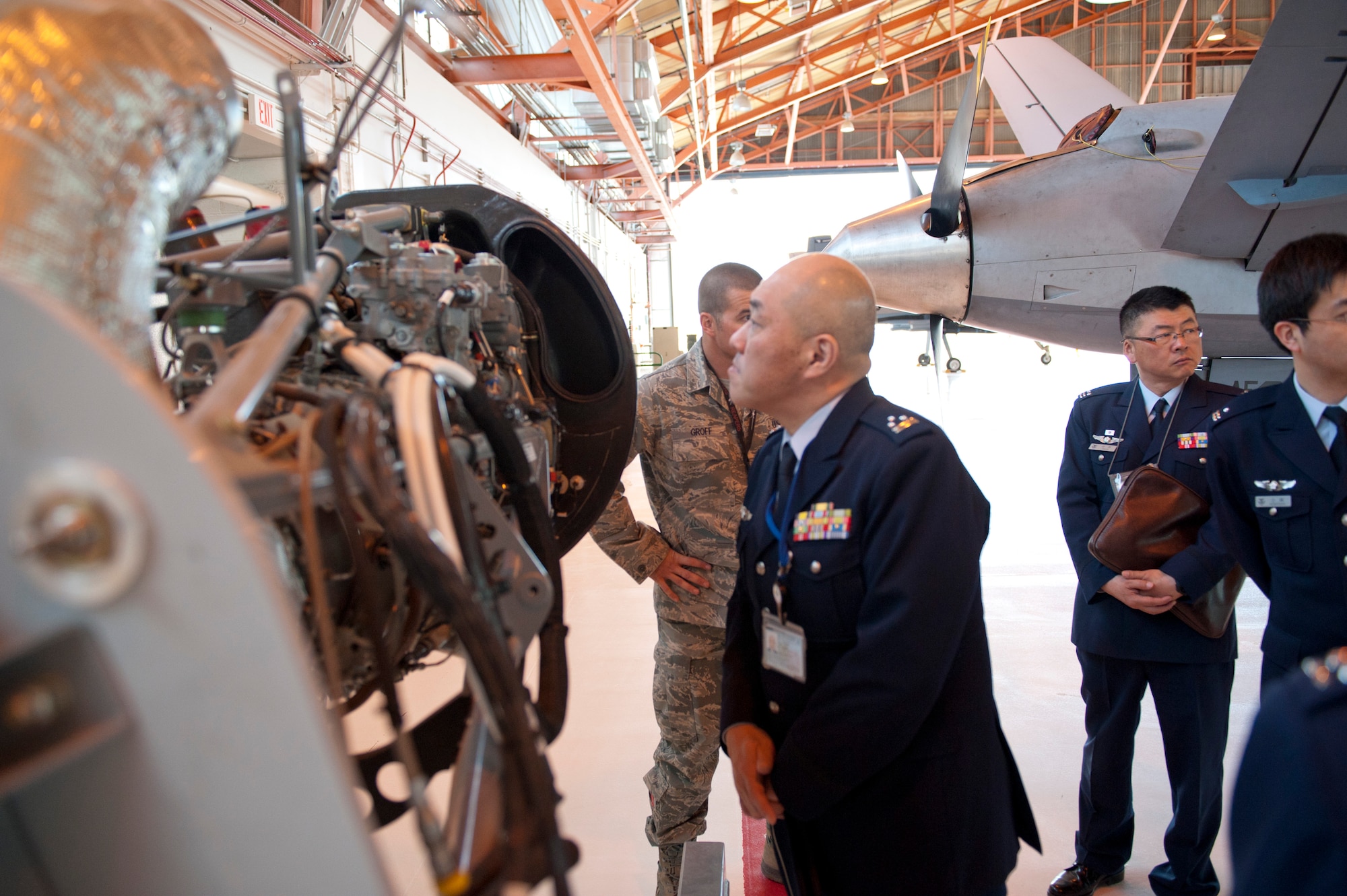 Colonel Junichi Kono, 2nd Section Weapons System Program Division chief, examines an MQ-9 Reaper engine at Holloman Air Force Base, N.M., March 19. The Remotely Piloted Aircraft program was briefed to the members of the Japan Air Self Defense Force. Their visit to Holloman AFB was part of an effort to bolster Japanese intelligence, surveillance and reconnaissance capability. (U.S. Air Force photo by Airman 1st Class Colin Cates/Released) 