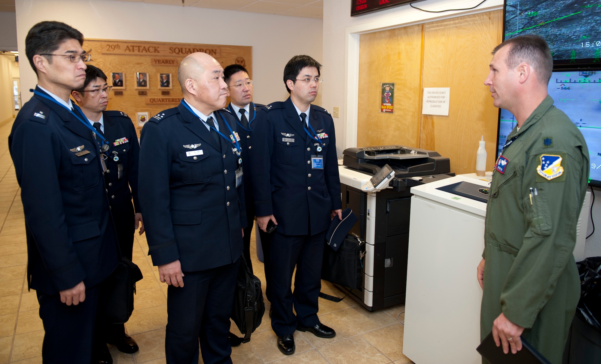 Lieutenant Col. Jeffery Patton, 9th Attack Squadron commander, welcomes members of the Japan Air Self Defense Force to Holloman Air Force Base, N.M., March 19. The Remotely Piloted Aircraft program was briefed to the members of the Japan Air Self Defense Force. Their visit to Holloman AFB was part of an effort to bolster Japanese intelligence, surveillance and reconnaissance capability. (U.S. Air Force photo by Airman 1st Class Colin Cates/Released) 