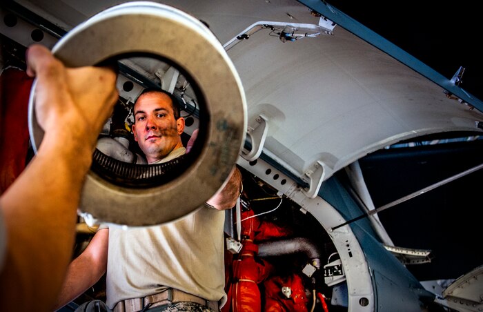 Senior Airman Paul Wilhems, 315th Maintenance Squadron Aircraft Electrical and Environmental Systems specialist, receives a new water separator bag/filter from Airman 1st Class Michael Ficken, 437th Maintenance Squadron ELEN specialist March 18, 2013, at Joint Base Charleston – Air Base, S.C. The filter removes condensation from the aircraft which prevents parts from freezing. Airmen and civilians from the 437th MXS ELEN shop perform maintenance on lighting equipment, motors, batteries, anti-icing controllers, caution and warning panels and many other parts. (U.S. Air Force photo / Airman 1st Class Tom Brading)