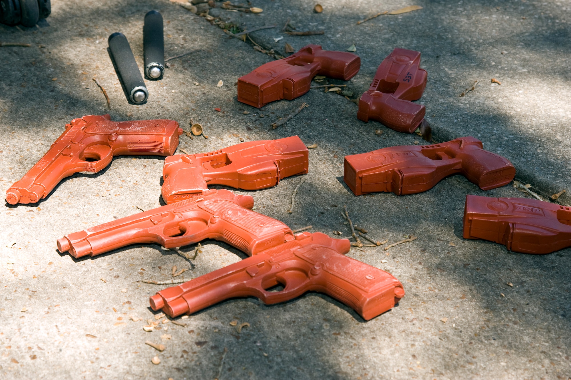 Training weapons, including plastic M-9s, Tasers and asp batons, are ready for use by security forces members during domestic violence training at base housing on Hurlburt Field, Fla., March 14, 2013. The training weapons allow security forces members to safely practice the use of force when necessary during domestic violence scenarios.  (U.S. Air Force photo by Airman 1st Class Michelle Vickers) 