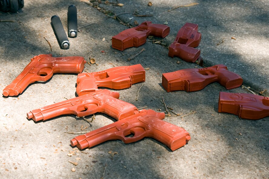 Training weapons, including plastic M-9s, Tasers and asp batons, are ready for use by security forces members during domestic violence training at base housing on Hurlburt Field, Fla., March 14, 2013. The training weapons allow security forces members to safely practice the use of force when necessary during domestic violence scenarios.  (U.S. Air Force photo by Airman 1st Class Michelle Vickers) 