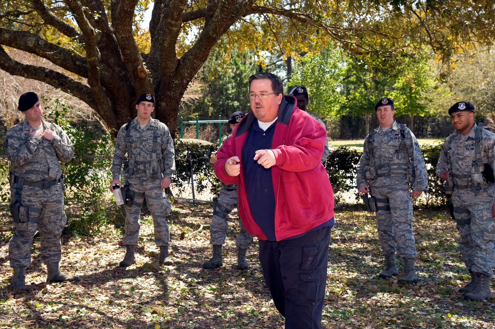 Paul Burgess, a training instructor of 1st Special Operations Security Forces Squadron, briefs 1st SOSFS members on how to respond to domestic violence incidents on base during domestic violence training at base housing on Hurlburt Field, Fla., March 14, 2013. The training allows security forces members to react to realistic domestic violence scenarios so they may be better prepared for real-world situations. (U.S. Air Force photo by Airman 1st Class Michelle Vickers) 