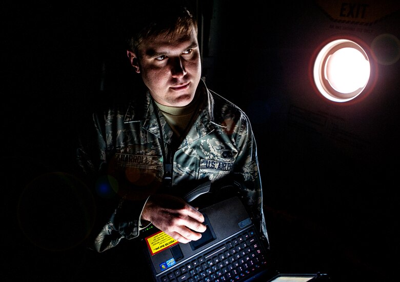 Airman 1st Class Ryan Carroll, 437th Aircraft Maintenance Squadron Aircraft Electronic and Environmental Systems specialist, checks his technical orders after inspecting a C-17 Globemaster III March 19, 2013, at Joint Base Charleston – Air Base, S.C. (U.S. Air Force photo / Airman 1st Class Tom Brading)
