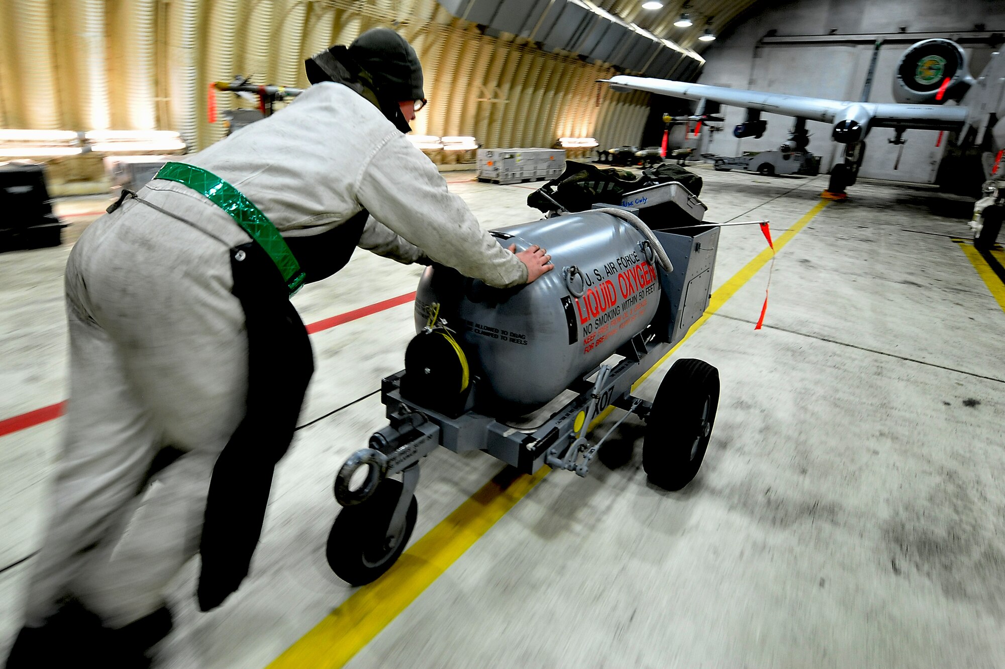 Senior Airman Ryan Holovich, 25th Aircraft Maintenance Unit crew chief, pushes a tank of liquid oxygen to service an A-10 Thunderbolt II during an Operation Readiness Exercise Beverly Midnight 13-02 at Osan Air Base, Republic of Korea, March 21, 2013. Airmen with the 25th AMU and all over the base are  constantly working  24/7 throughout the week-long exercise in all types of weather conditions. These types of exercises test Osan Airmen’s abilities during a heightened state of readiness while providing combat ready forces for close air support, air strike control, forward air control-airborne, combat search and rescue, counter air and fire, and interdiction in the defense of the Republic of Korea. (U.S. Air Force photo/Staff Sgt. Sara Csurilla)