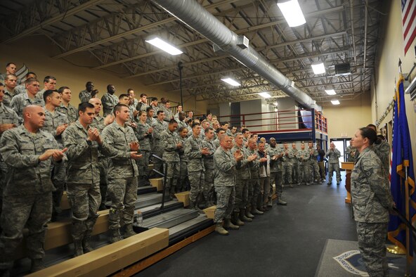 U.S. Air Force Airmen from the 824th Base Defense Squadron and 93d Air Ground Operations Wing leadership applaud Staff Sgt. Melissa Gschwend, 820th Base Defense Group standards and evaluation NCO, as she receives a Purple Heart Medal at Moody Air Force Base, Ga., March 15, 2013. The Purple Heart is a combat decoration awarded to those who are wounded by the enemy or posthumously to the next of kin of those who are killed in action or die of wounds received in action. (U.S. Air Force photo by Airman 1st Class Olivia Bumpers/Released)