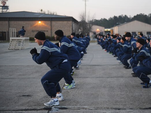 U.S. Air Force Airmen from the 820th Base Defense Group perform squats during a physical training (PT) session for the group’s 16th birthday at Moody Air Force Base, Ga., March 15, 2013. In honor of the group’s birthday, each squadron held a series of events such as PT, resiliency training and other group discussions. (U.S. Air Force photo by Airman 1st Class Olivia Bumpers/Released)