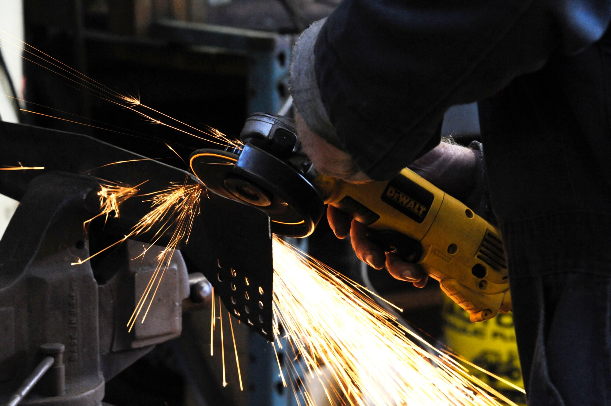 George Whitaker, 2nd Force Support Squadron Equipment Rental, sharpens lawnmower blades with a grinder on Barksdale Air Force Base, La., March 20. Equipment Rental offers lawnmower repair for Team Barksdale as well as paintball equipment and serving as the sign up area for swimming lessons during the summer months. (U.S. Air Force photo/Airman 1st Class Andrew Moua)