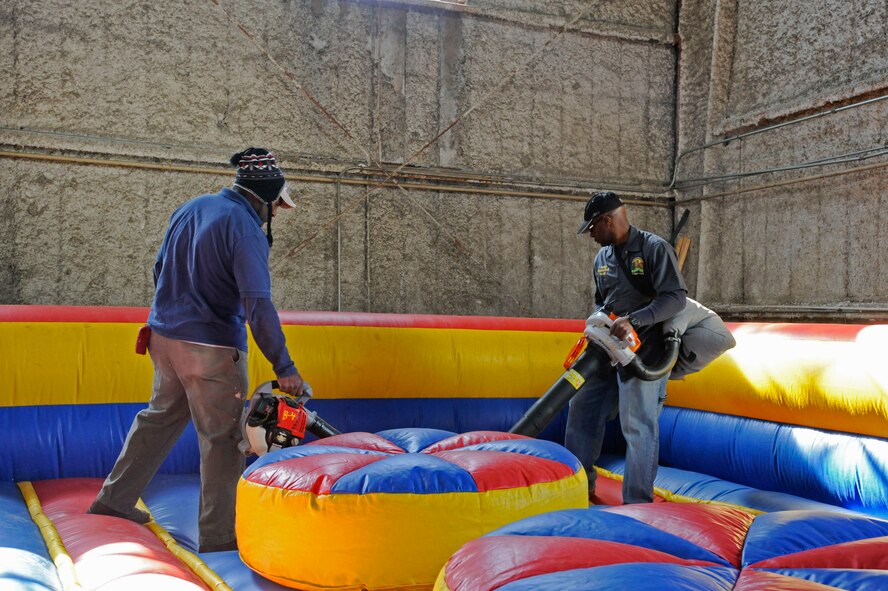 Albert Williams and Harold Player, 2nd Force Support Squadron Equipment Rental, clean a bouncy pit during routine maintenance and cleaning on Barksdale Air Force Base, La., March 20. Equipment Rental lends out and maintains equipment for Team Barksdale to use ranging from campers, grills, boats and trailers as well as offering lawn mower repair. (U.S. Air Force photo/Airman 1st Class Andrew Moua)