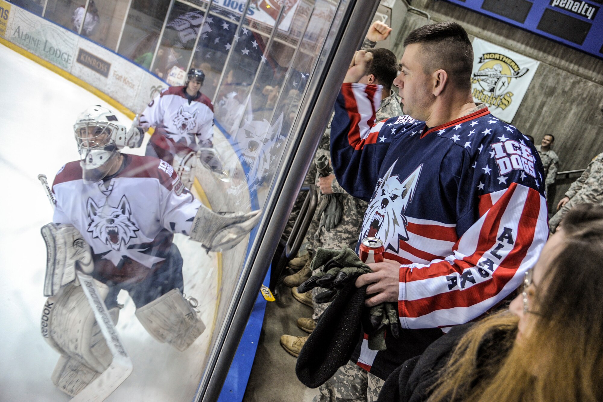 U.S. Army service members cheer on the Fairbanks Ice Dogs at Big Dipper Ice Arena Mar. 14, 2013, Fairbanks, Alaska.   The game was free to Soldiers, Airmen and their family members as part of a military appreciation game hosted by the Ice Dogs.  (U.S. Air Force Photo/Airman 1st Class Peter Reft)