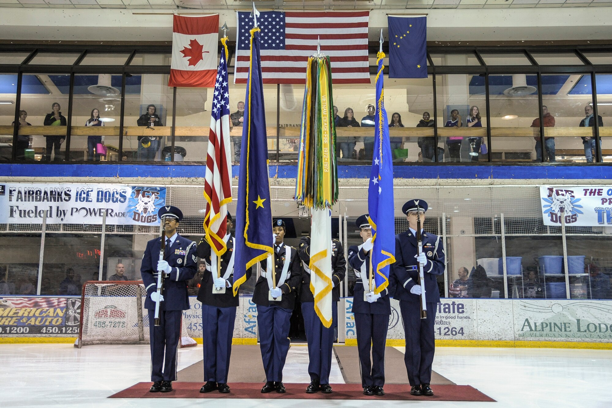 U.S. Air Force and U.S. Army Honor Guard service members present Colors at the Big Dipper Ice Arena Mar. 14, 2013, Fairbanks, Alaska.  The joint Honor Guard participated in the opening ceremony for the military appreciation game hosted by the Fairbanks Ice Dogs hockey team.  (U.S. Air Force Photo/Airman 1st Class Peter Reft)