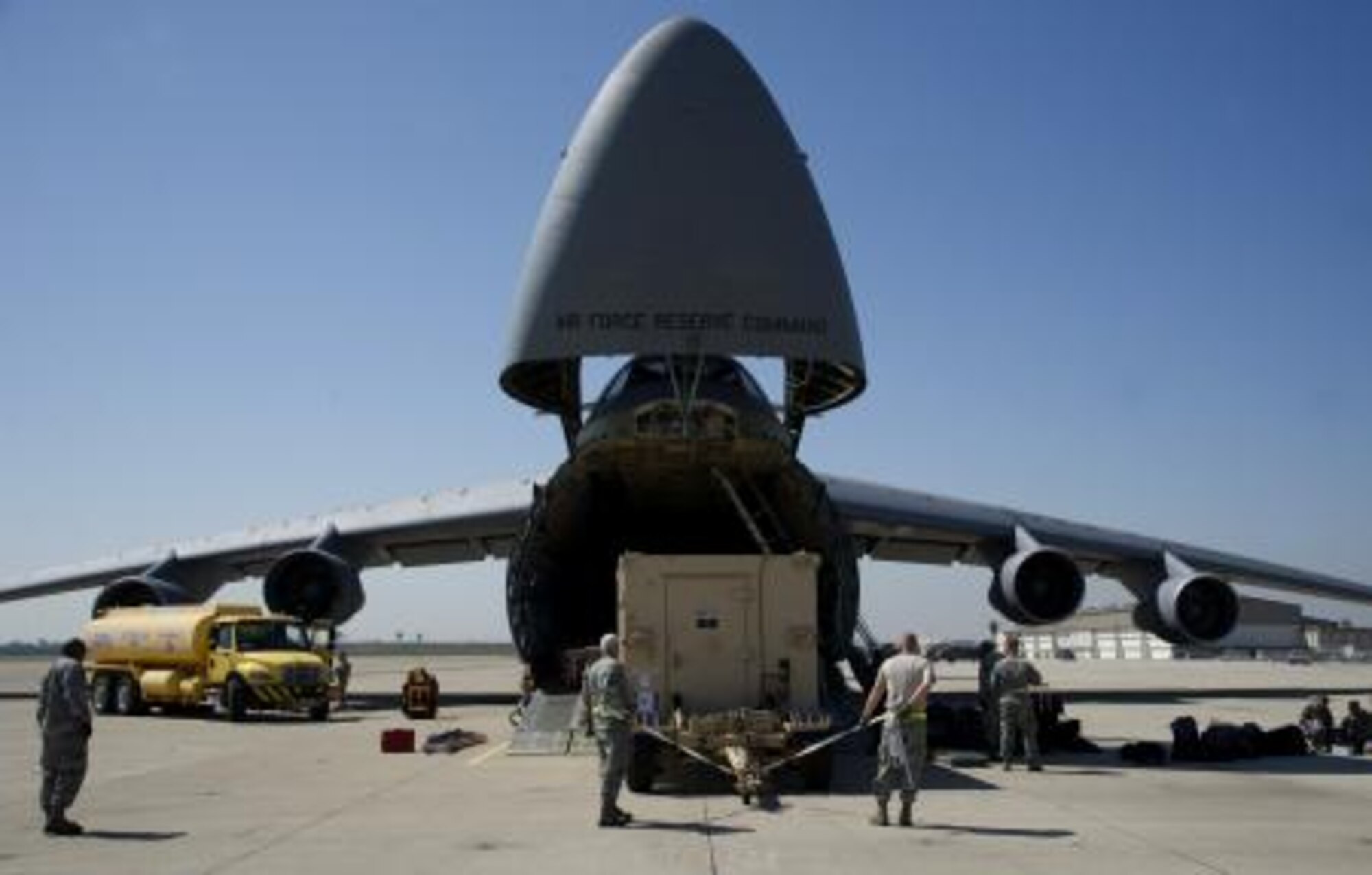 Members with the 433rd Airlift Wing down load a C-5A Galaxy during Patriot Hook on Los Alamitos Army Air Field, Calif., March 12, 2013. Patriot Hook is an Air Force Reserve Command sponsored exercise that focuses on maximizing the operational utilization for all participants in achieving fully integrated air mobility training objectives. (U.S. Air Force photo by Tech. Sgt. Bradley Church)