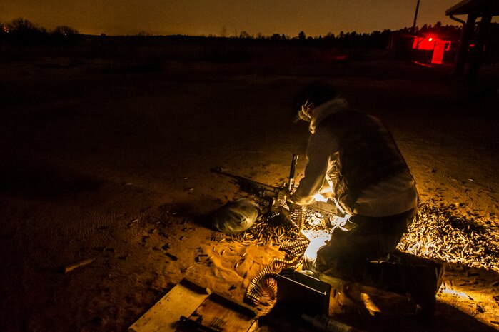 A member of the 628th Security Forces Squadron reloads a M240B machine gun during a weapons familiarization and proficiency training course March 14, 2013, at Ft. Jackson, S.C. The 628th SFS performed the training for M240B proficiency for use on patrol boats on the Cooper River and surrounding area. (U.S. Air Force photo/ Senior Airman George Goslin)