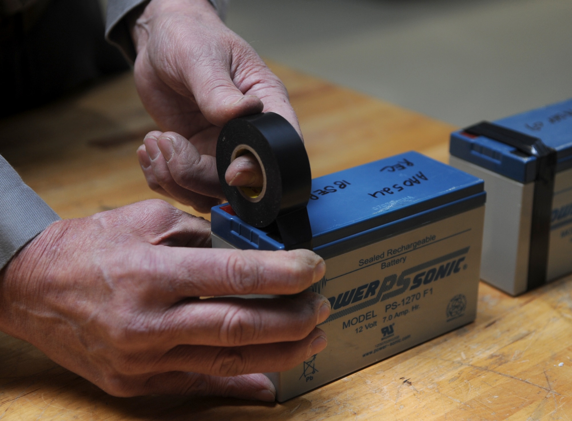 The bare contacts on rechargeable lithium, mercury, and nickel-metal batteries must be covered with electrical tape before turn in to hazardous waste disposal in the Environmental Office at Vance Air Force Base, Okla. (U.S. Air Force photo/ Airman 1st Class Frank Casciotta)