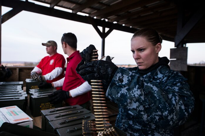 Petty Officer 2nd Class Jessicarose Thurber, 628th Security Forces Squadron master-at-arms, unloads ammunition during a weapons familiarization and proficiency training course March 14, 2013, at Ft. Jackson, S.C. The 628th SFS performed the training for M240B proficiency for use on patrol boats on the Cooper River and surrounding area. (U.S. Air Force photo/ Senior Airman George Goslin)
