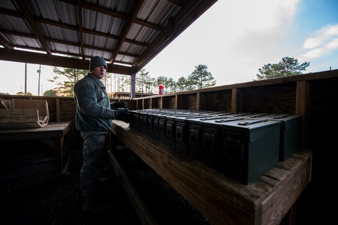 Senior Airman Collin Kirkpatrick, 628th Security Forces Squadron patrolman, lines up ammunition cans during a weapons familiarization and proficiency training course March 14, 2013, at Ft. Jackson, S.C. The 628th SFS performed the training for M240B proficiency while on patrol boats on the Cooper River and surrounding area. (U.S. Air Force photo/ Senior Airman George Goslin)