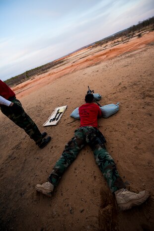 Petty Officer 1st Class Bradley Nguyen, 628th SFS gunner's mate, sights a M240B machine gun during a weapons familiarization and proficiency training course March 14, 2013, at Ft. Jackson, S.C. The 628th SFS performed the training for M240B proficiency for use on patrol boats on the Cooper River and surrounding area. (U.S. Air Force photo/ Senior Airman George Goslin)