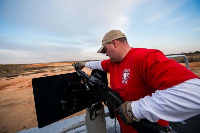 Petty Officer 2nd Class Jeremiah Parker, 628th Security Forces Squadron master-at-arms, mounts a M240B machine gun during a weapons familiarization and proficiency training course March 14, 2013, at Ft. Jackson, S.C.  The 628th SFS performed the training for M240B proficiency for use on patrol boats on the Cooper River and surrounding area. (U.S. Air Force photo/ Senior Airman George Goslin)