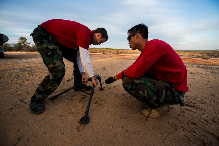 Petty Officer 2nd Class Michael Harkey, 628th Security Forces Squadron master-at-arms, and Petty Officer 1st Class Bradley Nguyen, 628th SFS gunner's mate, assemble a tripod for a M240B machine gun during a weapons familiarization and proficiency training course March 14, 2013, at Ft. Jackson, S.C.  The 628th SFS performed the training for M240B proficiency for use on patrol boats on the Cooper River and surrounding area. (U.S. Air Force photo/ Senior Airman George Goslin)