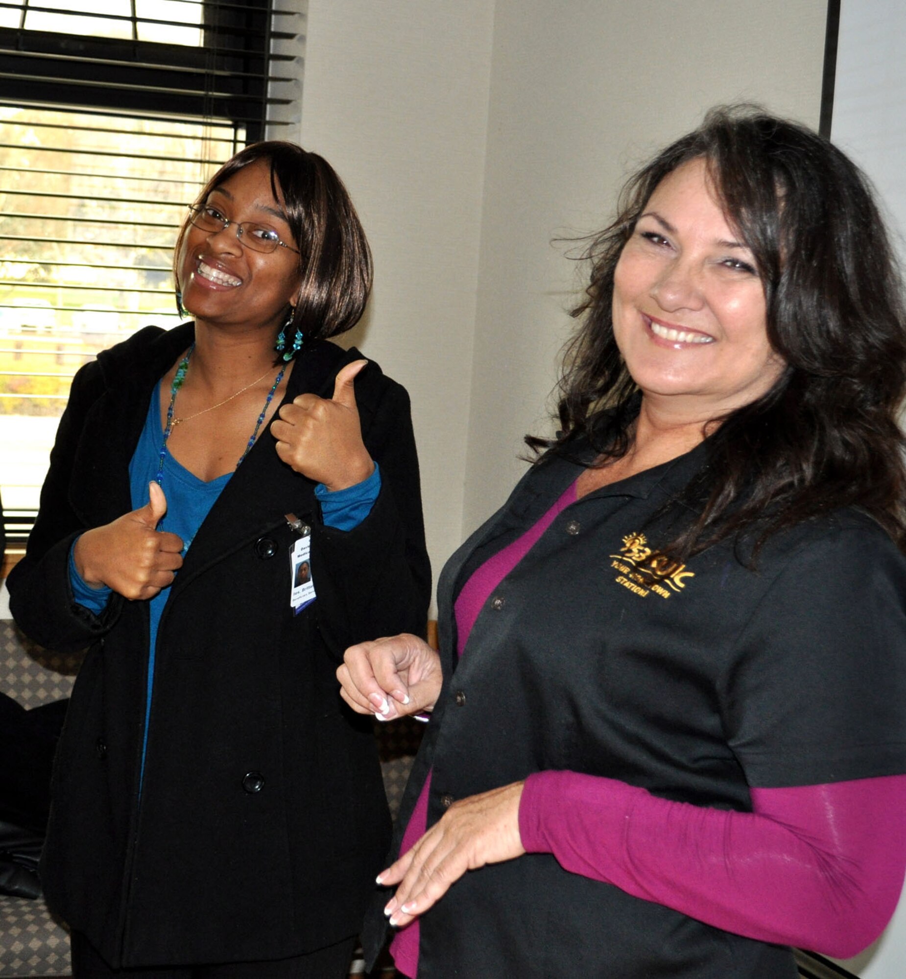 TRAVIS AIR FORCE BASE, Calif. -- Coffee Break Coordinator Barbara Hoover, with KUIC 95.3 radio, and Staff Sgt. Brittany Iles give the camera a big thumbs up for another successful Coffee Break. A regular listener, Iles called the station to request the break for her unit, the 349th AMDS, at Travis AFB. Hoover said she does quite a few Coffee Breaks at Travis, and has three more coming up soon. "We love the folks out here at Travis, they're loyal listeners," she said. When not serving in the Reserve with the 349th AMDS, Iles works full-time at David Grant U.S. Air Force Medical Center. (U.S. Air Force photo/Senior Master Sgt. Ellen Hatfield)
