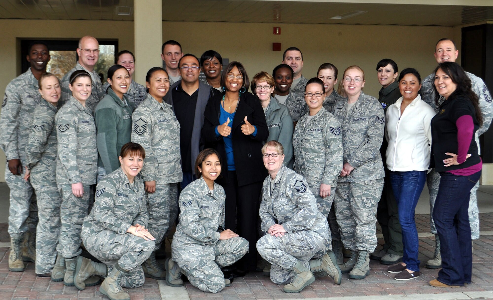 TRAVIS AIR FORCE BASE, Calif. -- Airmen with the 349th Aerospace Medicine Squadron enjoy bagels, pastries and coffee, courtesy of KUIC 95.3, "Your hometown station." The station provides Coffee Breaks for loyal listeners who call in and request one for their office. Barbara Hoover, Coffee Break Coordinator, brought their breakfast break to Travis Air Force Base Mar. 6, 2013, for about 30 members of the squadron. The Airmen made a phone call back to the station, so they could express their gratitude with a lot of whooping and hollering. (U.S. Air Force photo/Senior Master Sgt. Ellen Hatfield) Second photo:
Coffee Break Coordinator Barbara Hoover, with KUIC 95.3 radio, and Staff Sgt. Brittany Iles give the camera a big thumbs up for another successful Coffee Break. A regular listener, Iles called the station to request the break for her unit, the 349th AMDS, at Travis AFB. Hoover said she does quite a few Coffee Breaks at Travis, and has three more coming up soon. "We love the folks out here at Travis, they're loyal listeners," she said. When not serving in the Reserve with the 349th AMDS, Iles works full-time at David Grant U.S. Air Force Medical Center. (U.S. Air Force photo/Senior Master Sgt. Ellen Hatfield)
