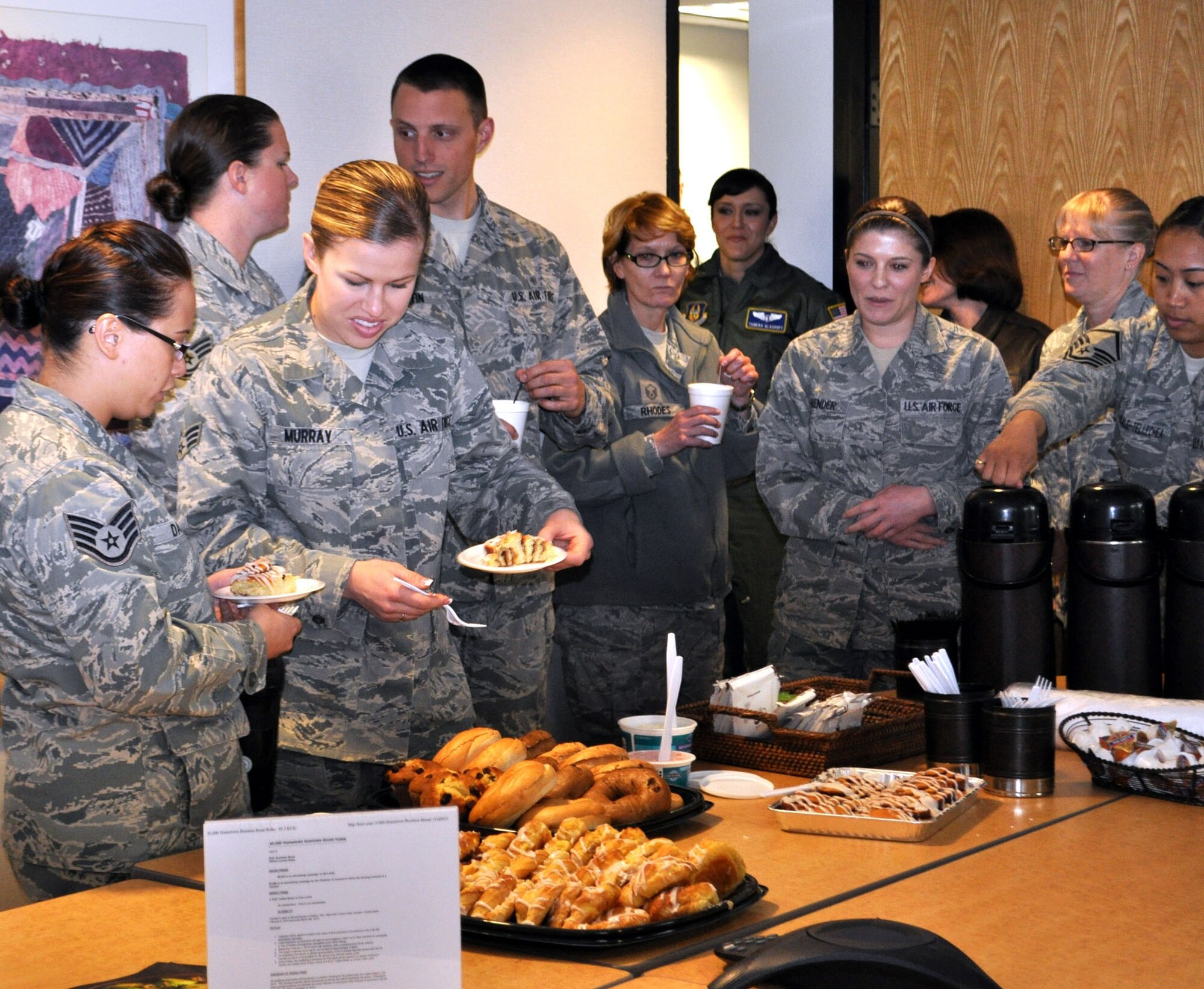 TRAVIS AIR FORCE BASE, Calif. -- Airmen with the 349th Aerospace Medicine Squadron enjoy bagels, pastries and coffee, courtesy of KUIC 95.3, "Your hometown station." The station provides Coffee Breaks for loyal listeners who call in and request one for their office. Barbara Hoover, Coffee Break Coordinator, brought their breakfast break to Travis Air Force Base Mar. 6, 2013, for about 30 members of the squadron. The Airmen made a phone call back to the station, so they could express their gratitude with a lot of whooping and hollering. (U.S. Air Force photo/Senior Master Sgt. Ellen Hatfield) Second photo:
Coffee Break Coordinator Barbara Hoover, with KUIC 95.3 radio, and Staff Sgt. Brittany Iles give the camera a big thumbs up for another successful Coffee Break. A regular listener, Iles called the station to request the break for her unit, the 349th AMDS, at Travis AFB. Hoover said she does quite a few Coffee Breaks at Travis, and has three more coming up soon. "We love the folks out here at Travis, they're loyal listeners," she said. When not serving in the Reserve with the 349th AMDS, Iles works full-time at David Grant U.S. Air Force Medical Center. (U.S. Air Force photo/Senior Master Sgt. Ellen Hatfield)
