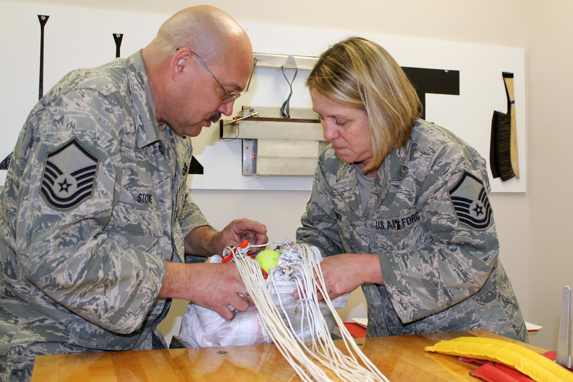 130319-Z-VA676-067 - Master Sgt. Kathy Smith and Master Sgt. Ed Stone work together to pack an ACES II C-9 canopy parachute following an inspection of the parachute at Selfridge Air National Guard Base, Mich., March 19, 2013. Air Force parachutes are inspected at least annually and then re-packed. Stone and Smith are members of the aircrew flight equipment shop of the 127th Operations Support Flight, a component of the 127th Wing, Michigan Air National Guard. (Air National Guard photo by TSgt. Dan Heaton)