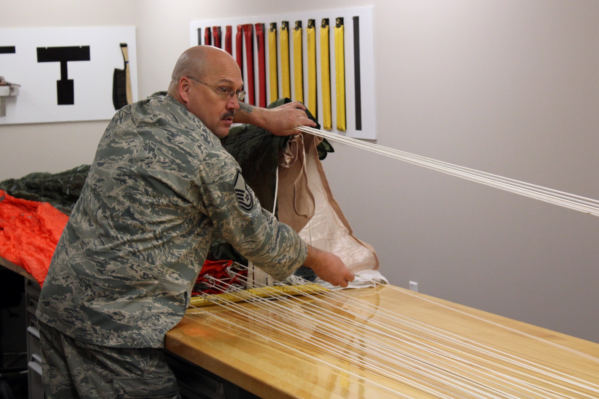 130319-Z-VA676-033 - Master Sgt. Ed Stone inspects some of the 28 cords that are part of the ACES II C-9 canopy parachute during an inspection of the parachute at Selfridge Air National Guard Base, Mich., March 19, 2013. Air Force parachutes are inspected at least annually and then re-packed. Stone is a member of the aircrew flight equipment shop of the 127th Operations Support Flight, a component of the 127th Wing, Michigan Air National Guard. (Air National Guard photo by TSgt. Dan Heaton)