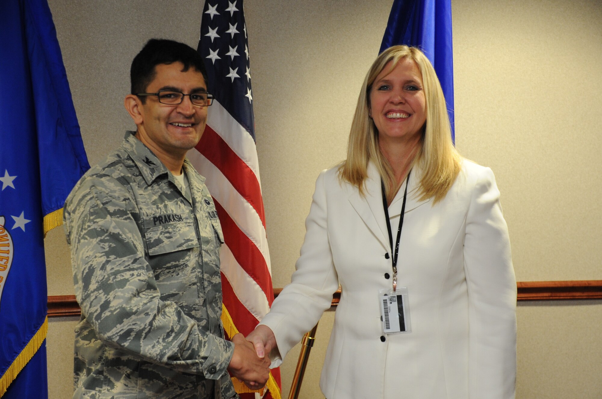 Colonel Om Prakash, vice commander of the 82nd Training Wing, congratulates Beverly Fisher of the 363rd Training Squadron. Fisher was instrumental in delivering two MQ-9 aircraft to Sheppard Air Force Base, with one pledged for armament training. (U.S. Air Force photo by Airman 1st Class Jelani Gibson)