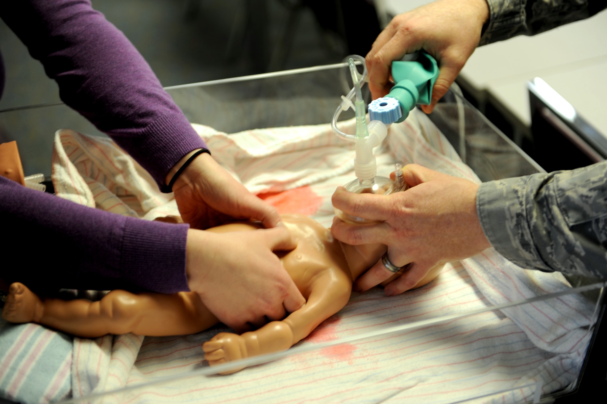 Capt. Adam Hebdon, a third-year resident in the Scott Air Force Base's Family Medicine Residency program practices neonatal resuscitation during a simulation exercise March 11 at St. Louis University Family Medicine in Belleville, Ill.  This exercise helps residents simulate the steps they must take when a baby doesn't breath when he or she is born.  (U.S. Air Force photo/Staff Sgt. Maria Bowman)