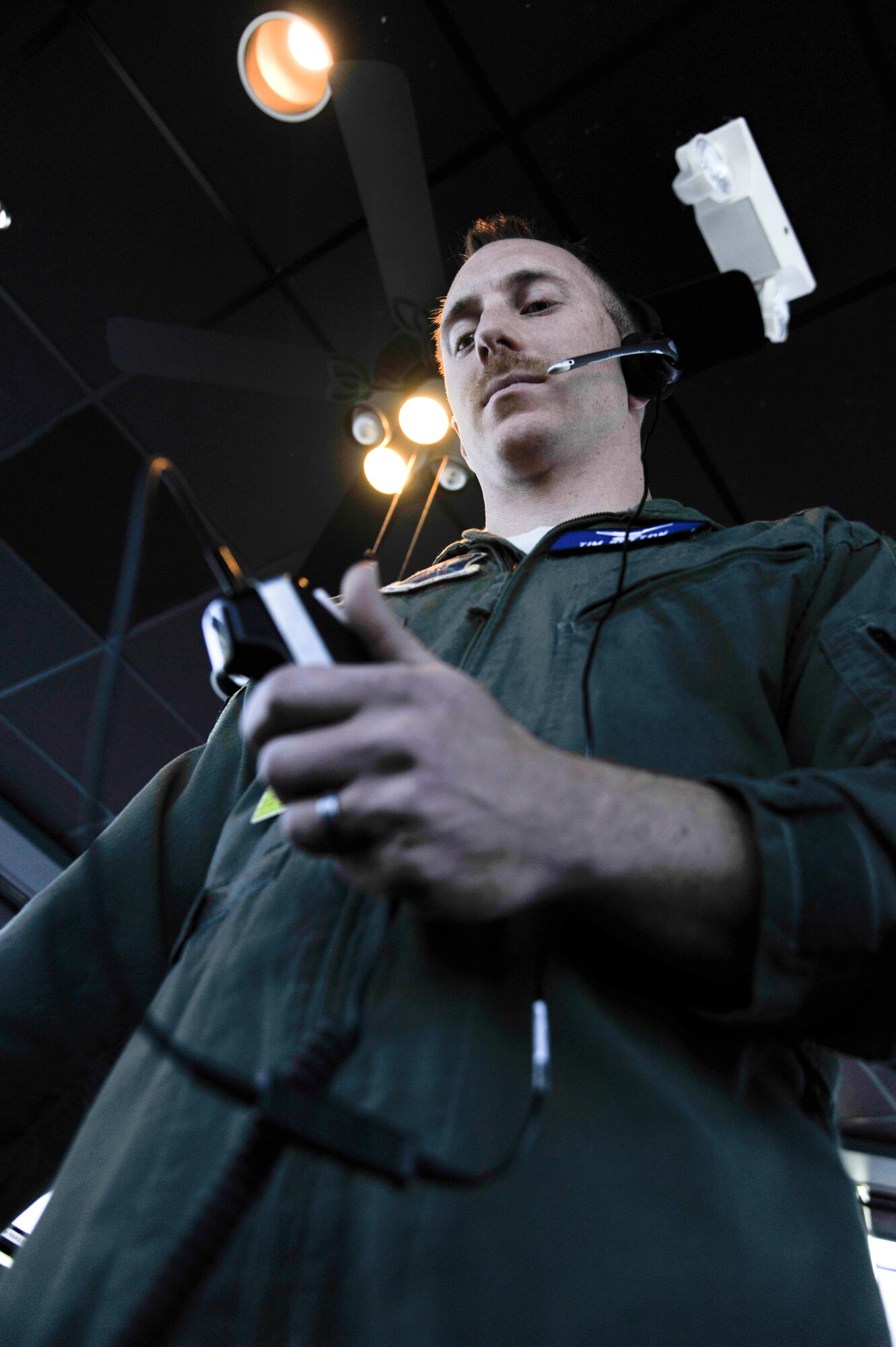 Major Tim Sutton, 509th Operations Support Squadron flying supervisor, communicates using a headset at Whiteman Air Force Base, Mo., March 11, 2013. Air traffic controllers rely on headsets to deliver their messages concerning take-off and landing statuses. (U.S. Air Force photo by Airman 1st Class Keenan Berry/Released)