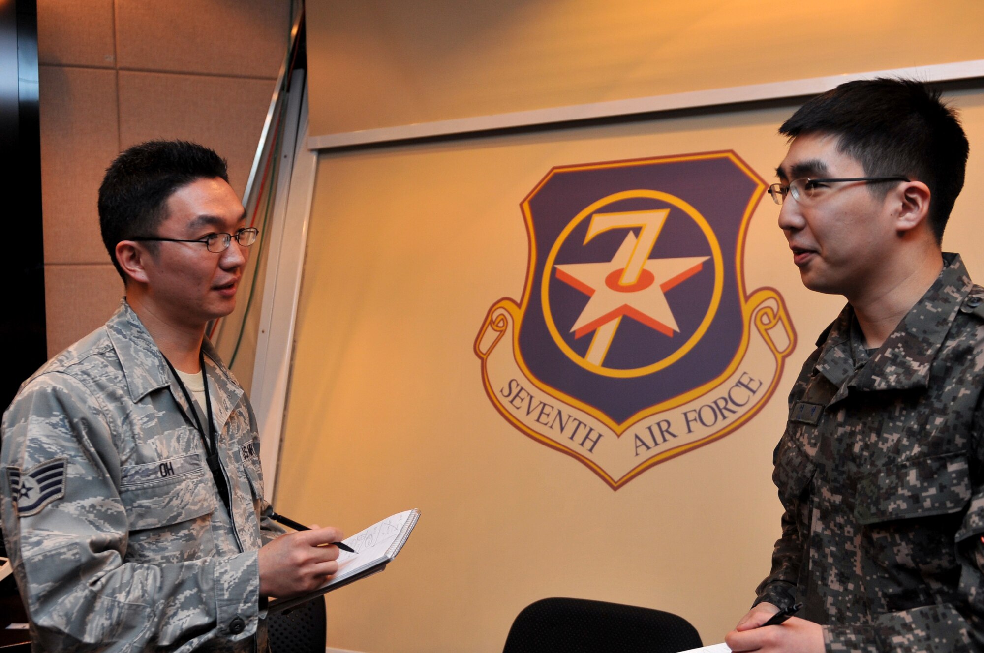 U.S. Air Force Staff Sgt. Hyo K. Oh and Republic of Korea Air Force 1st Lt. Lee, Suk-Hyung, 7th Air Force Air Component Command plans and coordination directorate senior interpreters, converse after a briefing during Exercise Key Resolve at Osan Air Base, Republic of Korea, March 20, 2013. Training exercises like Key Resolve are carried out in the spirit of the 1953 ROK-U.S. Mutual Defense Treaty. These exercises highlight the longstanding partnership and enduring friendship between the United Nations Command sending state nations, help ensure peace and security on the peninsula, and reaffirm the U.S. commitment to the region. (U.S. Air Force photo/Airman 1st Class Hailey R. Davis) 