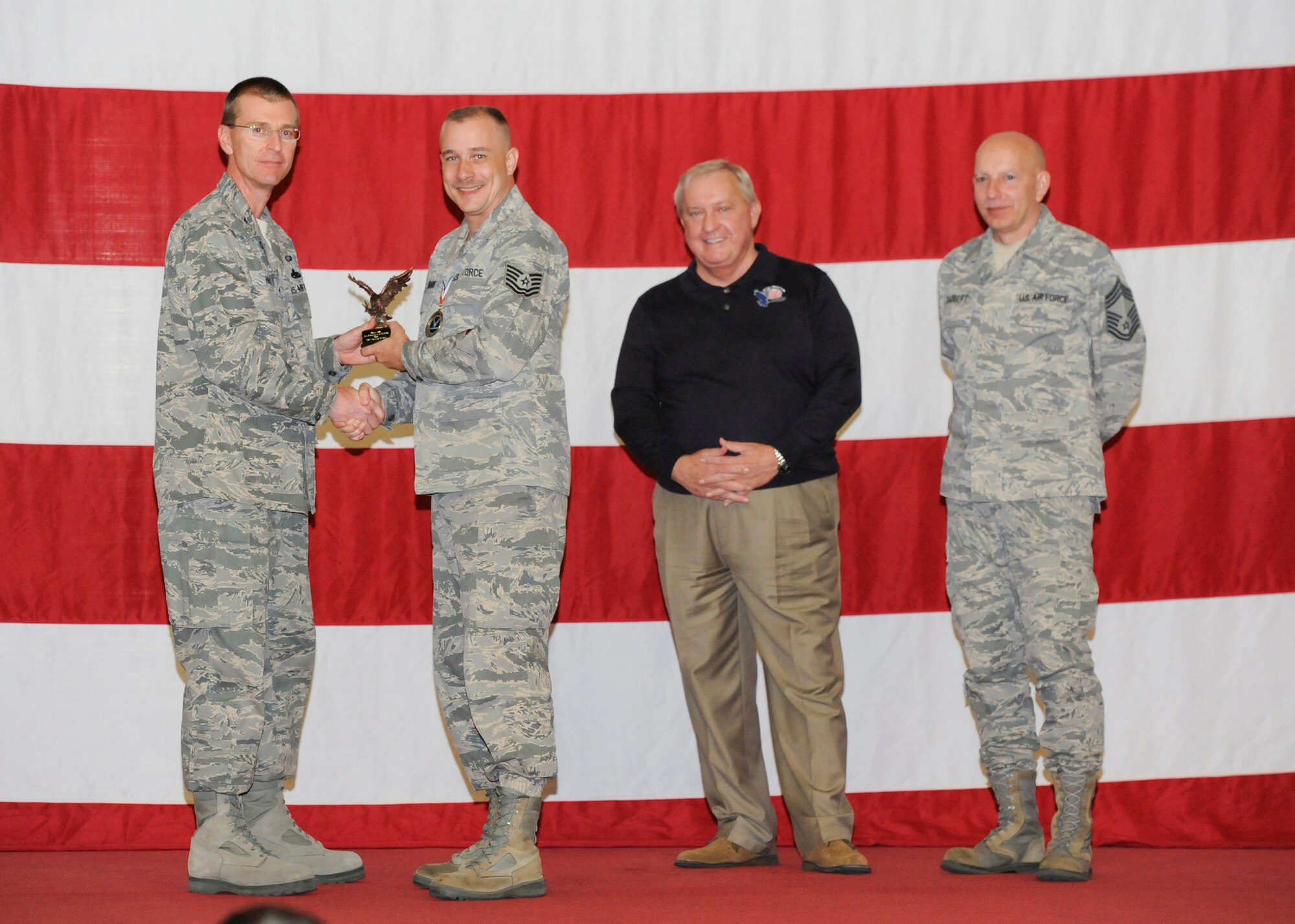 Tech. Sgt. Ronald Brooks, 325th Maintenance Operations Squadron, receives the award for Air Combat Command Analysis of the Year Maintenance Manager of the Year in the NCO category from Col. Curtis Hafer, 325th Maintenance Group commander, and Chief Master Sgt. Terry Gabbert, 325th MXG superintendent, and retired ninth Chief Master Sergeant of the Air Force, Chief Master Sgt. James Binnicker, during the 2012 Maintenance and Staff Professionals of the Year banquet in Hangar 1 March 15. The MPOY banquet recognizes the achievements of the maintenance group and honors maintenance professionals each year. (U.S. Air Force photo by Chris Cokeing)