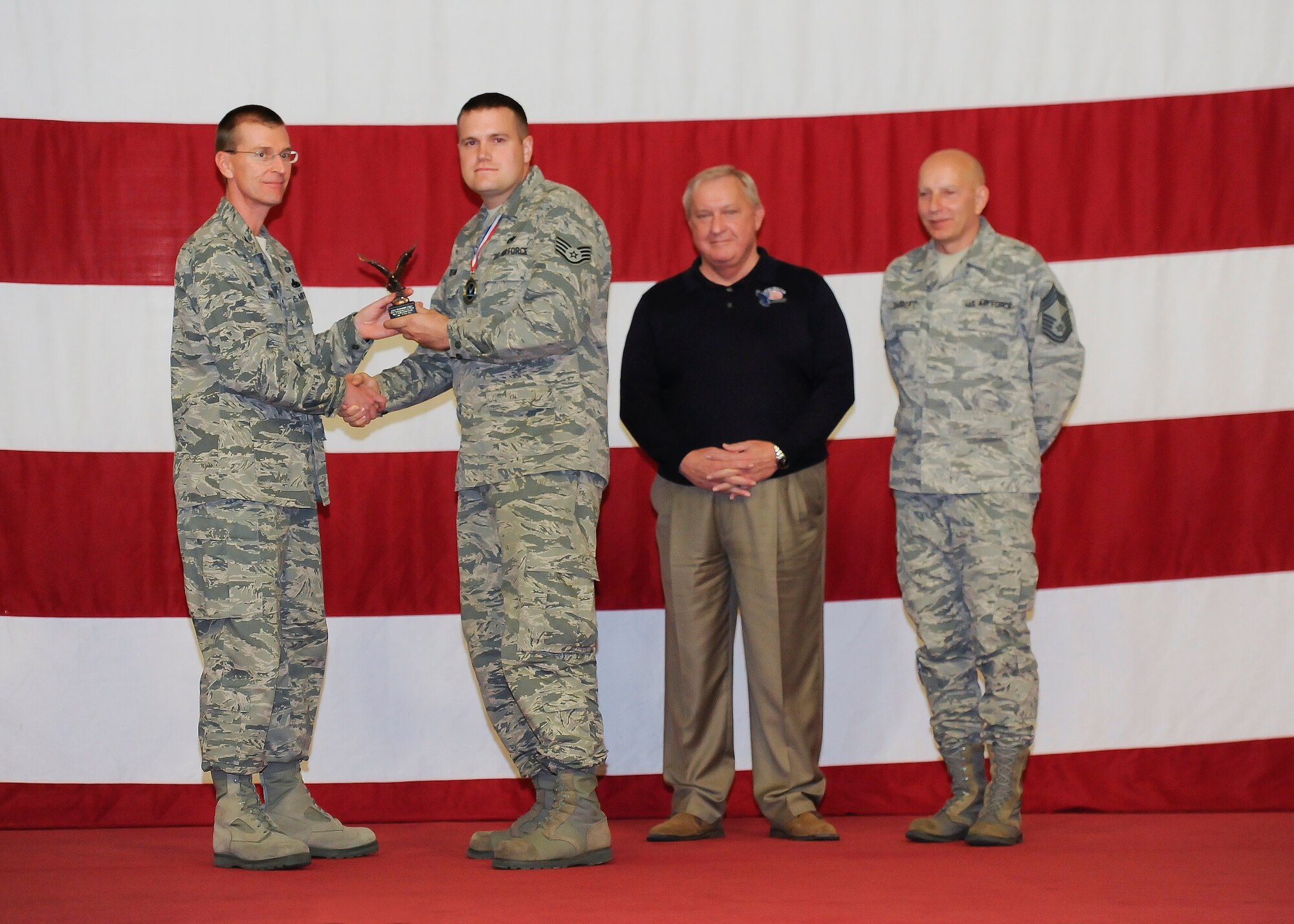 Staff Sgt. Benjamin Dean, 325th Maintenance Squadron, receives the award for the 325th Fighter Wing Foreign Object Preventer of the Year from Col. Curtis Hafer, 325th Maintenance Group commander, and Chief Master Sgt. Terry Gabbert, 325th MXG superintendent, and retired ninth Chief Master Sergeant of the Air Force, Chief Master Sgt. James Binnicker, during the 2012 Maintenance and Staff Professionals of the Year banquet in Hangar 1 March 15. The MPOY banquet recognizes the achievements of the maintenance group and honors maintenance professionals each year. (U.S. Air Force photo by Chris Cokeing)