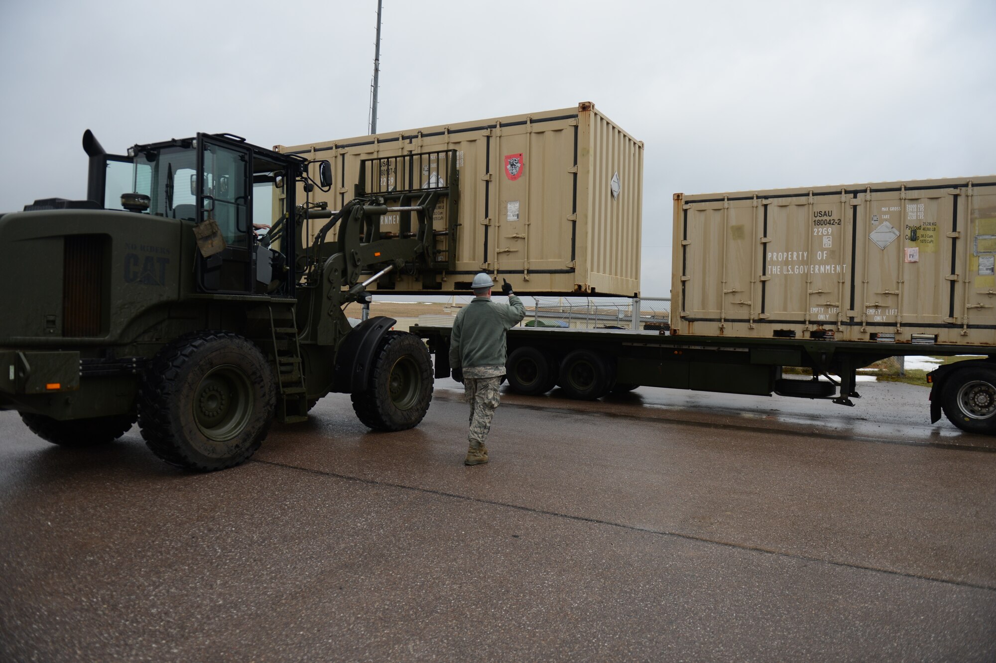SPANGDAHLEM AIR BASE, Germany – U.S. Air Force Airmen from the 52nd Equipment Maintenance Squadron place large intermodal shipping containers onto the bed of a truck near the ammunition bomb pad March 19, 2013. The International Maritime Dangerous Goods Code containers are qualified and capable of holding hazardous materials or dangerous goods. The 52nd EMS used the containers to store munitions, but are now being transported to Miesau Army Depot for storage. (U.S. Air Force photo by Airman 1st Class Gustavo Castillo/Released)