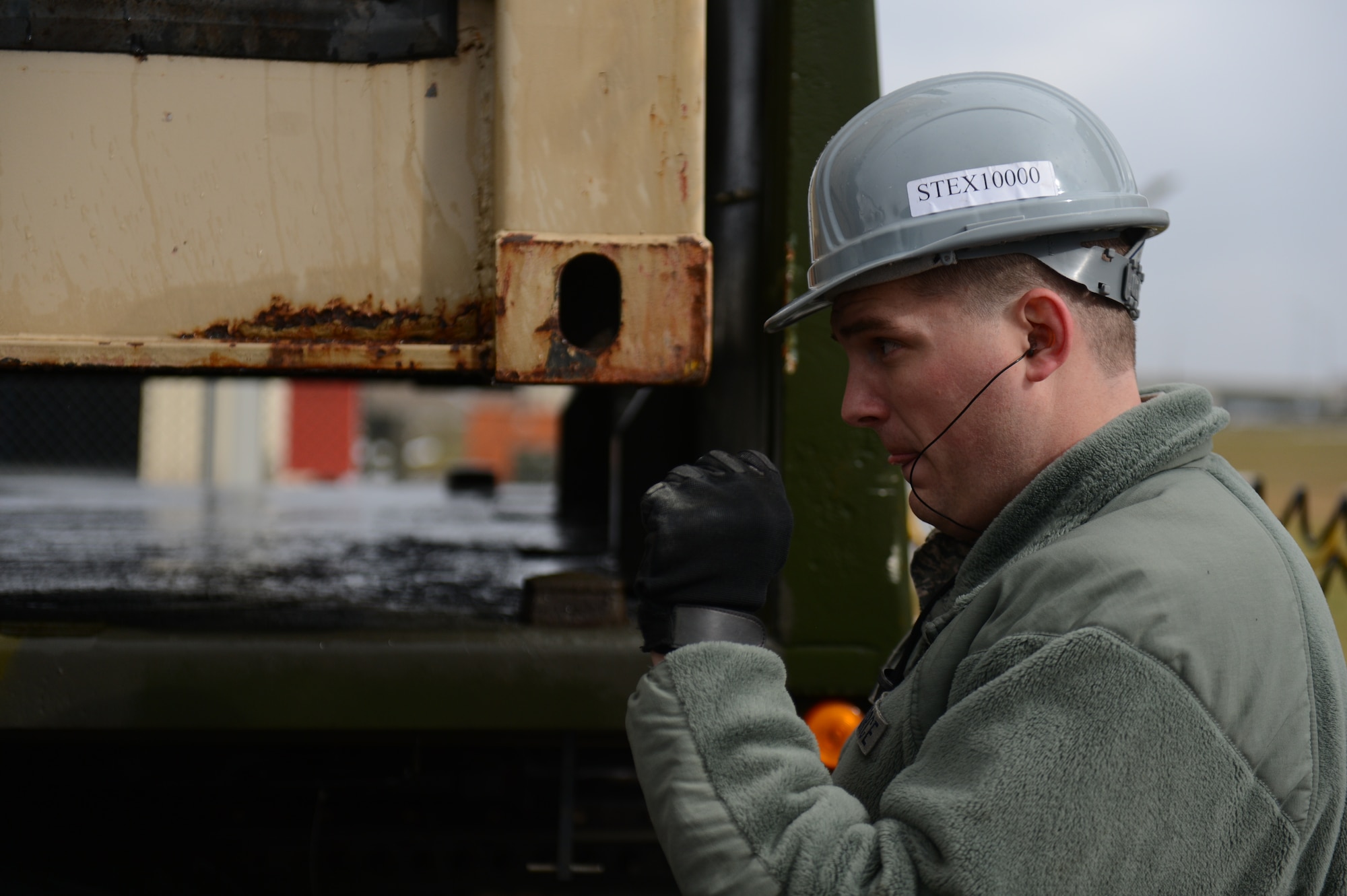 SPANGDAHLEM AIR BASE, Germany – U.S. Air Force Staff Sgt. Zachary Zeman, 52nd Equipment Maintenance Squadron munitions storage crew chief from Lone Tree, Iowa, directs a forklift driver  where to load an intermodal shipping container on a truck bed near the ammunition bomb pad March 19, 2013. The redistribution of the shipping containers directly supports the munitions movement plan directed from U.S. Forces in Europe. (U.S. Air Force photo by Airman 1st Class Gustavo Castillo/Released)