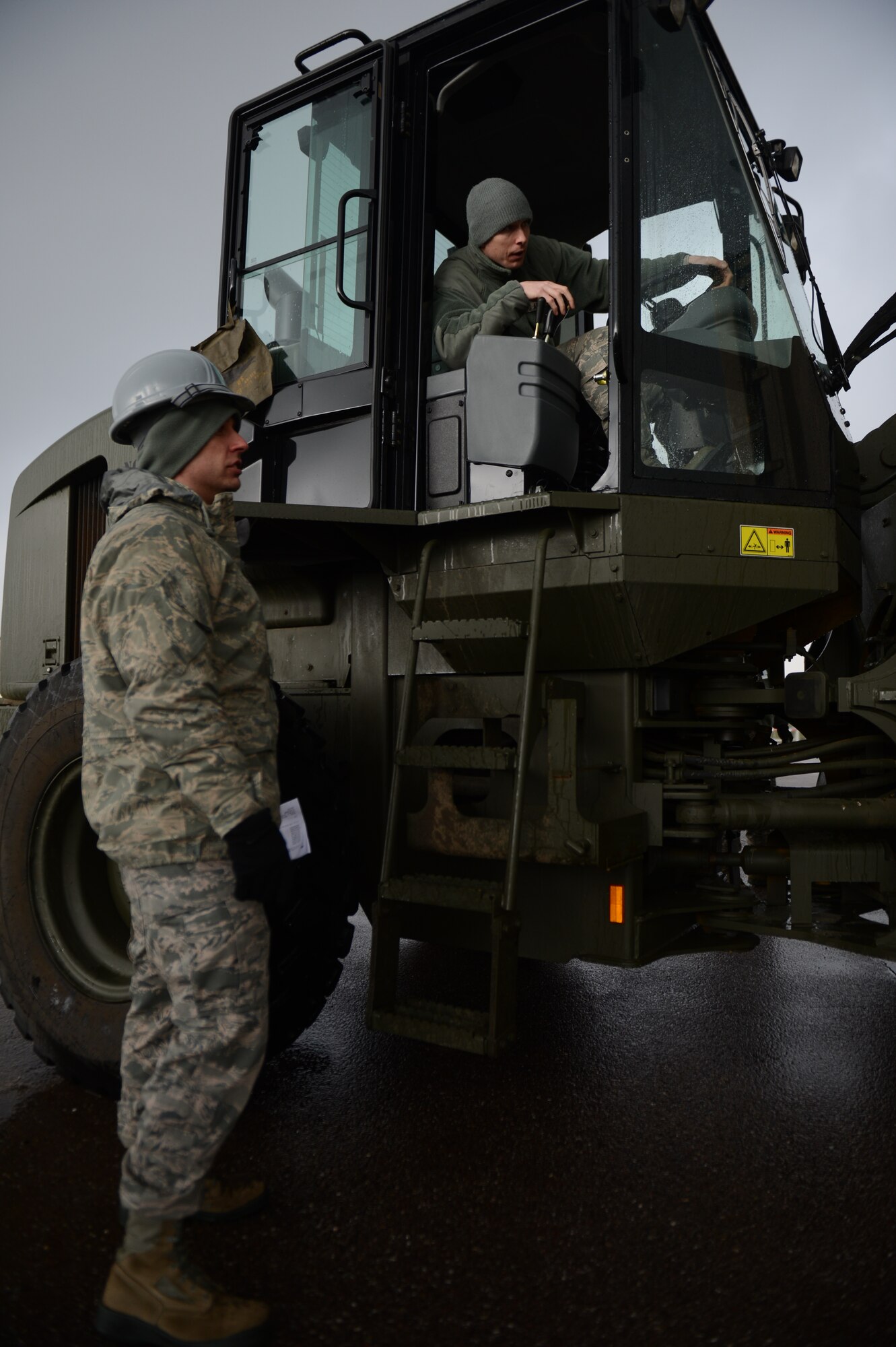 SPANGDAHLEM AIR BASE, Germany – U.S. Air Force Tech. Sgt. Michael Martin, 52nd Equipment Maintenance Squadron assistant NCO in charge of munitions inspection from Knoxville, Tenn., speaks to U.S. Air Force Senior Airman Dillon Meredith, 52nd EMS storage crew chief from Green Bare, Calif., about the movement and placement of intermodal shipping containers near the ammunition bomb pad March 19, 2013. The Department of Defense containers must be delivered to another storage yard to support allied interests. (U.S. Air Force photo by Airman 1st Class Gustavo Castillo/Released)