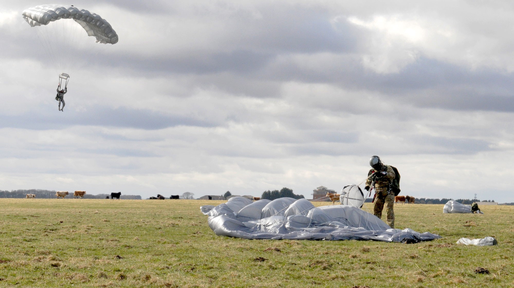 Members of the 321st Special Tactics Squadron touchdown March 12, 2013, in a field outside of Sculthorpe, England, during the unit’s Jump Week training exercise. The pararescuemen and combat controllers in the 321st STS use free-fall jumps to tactically infiltrate hostile or austere locations requiring their specialized recovery and support skills. (U.S. Air Force photo by 1st Lt. Christopher Mesnard/Released)