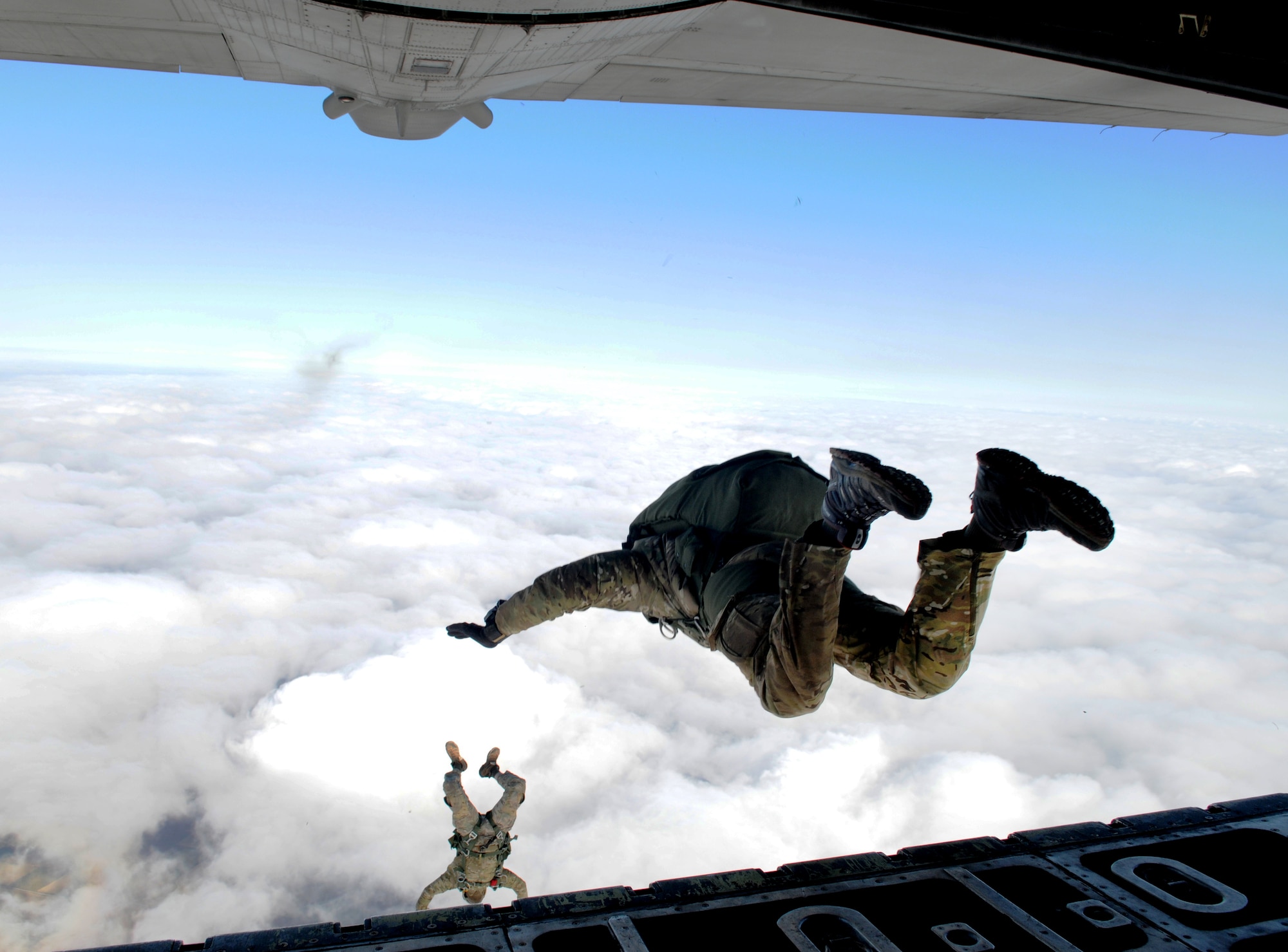 Pararescuemen from the 321st Special Tactics Squadron begin their 10,000-foot journey back to solid ground March 12, 2013, near Sculthorpe, England. The 321st STS conducted a week-long jump exercise to keep its members proficient in their ability to tactically insert into combat zones. In addition to their ability to conduct free-fall missions, pararescuemen are specially trained to conduct combat recovery operations in austere locations. (U.S. Air Force photo by 1st Lt. Christopher Mesnard/Released)