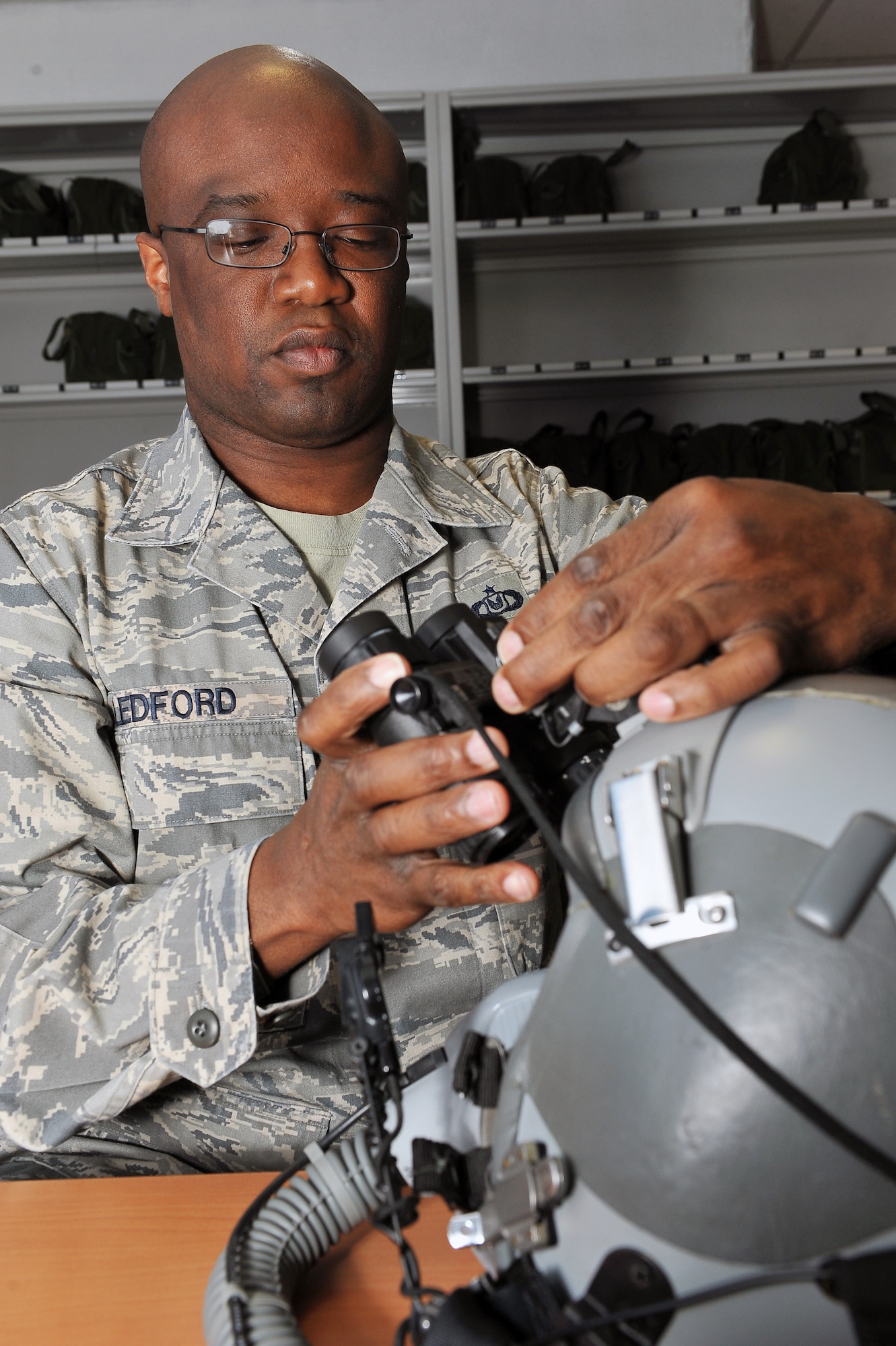 Tech. Sgt. Timothy Ledford, 86th Operations Support Squadron aircrew flight equipment craftsman, attaches night-vision goggles to a helmet, March 20, 2013, Ramstein Air Base, Germany. Ledford was honored with the aircrew flight equipment NCO of the year award for his outstanding accomplishments. (U.S. Air Force photo/Airman 1st Class Dymekre Allen)
