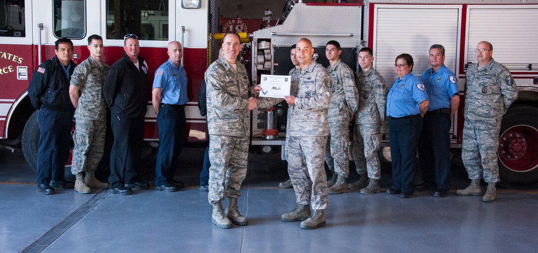 Tech. Sgt. Matthew Hare, 47th Civil Engineer Squadron assistant chief of operations, poses with Col. Tom Murphy, 47th Flying Training Wing commander, after being presented the XLer of the week award at Laughlin Air Force Base, Texas, Feb. 28, 2013. The XLer is a weekly award chosen by wing leadership and given to those who consistently make outstanding contributions to Laughlin and their unit. (U.S. Air Force photo/Senior Airman Nathan Maysonet)